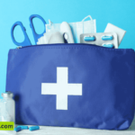 A blue first aid kit box with a red cross on it, containing various medical supplies and equipment.