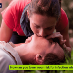 A Lady giving rescue breaths (how can you lower your risk for infection when giving breaths?)